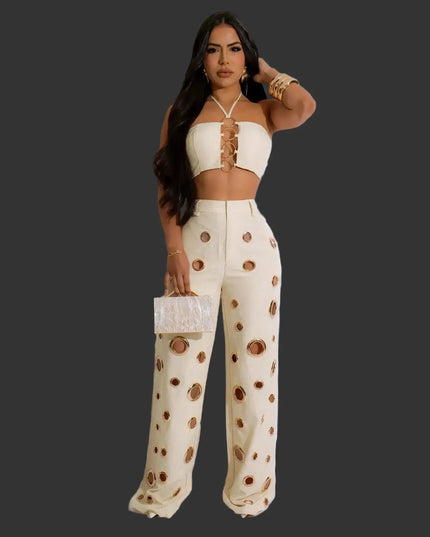 Woman wearing a cream-colored outfit with brown polka dots on a white background