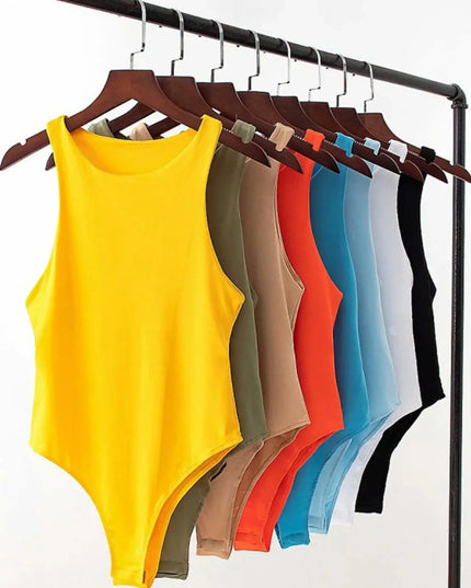 Yellow tank top on a hanger with other colored tank tops on a rack against a white background