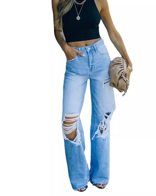 Woman wearing light blue ripped jeans on a white background