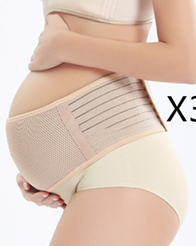 Pregnant woman wearing a beige maternity support belt on a white background