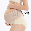 Pregnant woman wearing a beige maternity support belt on a white background