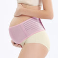 Pregnant woman wearing a pink maternity belt on a white background