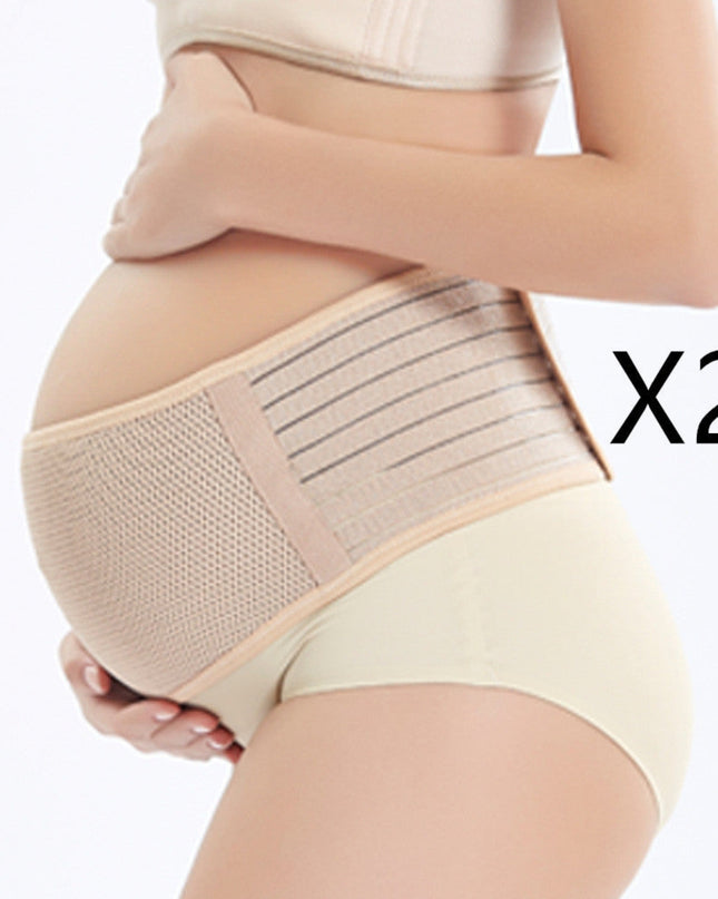 Pregnant woman wearing a beige maternity support belt on a white background