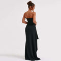 Woman wearing a black strapless gown on a white background
