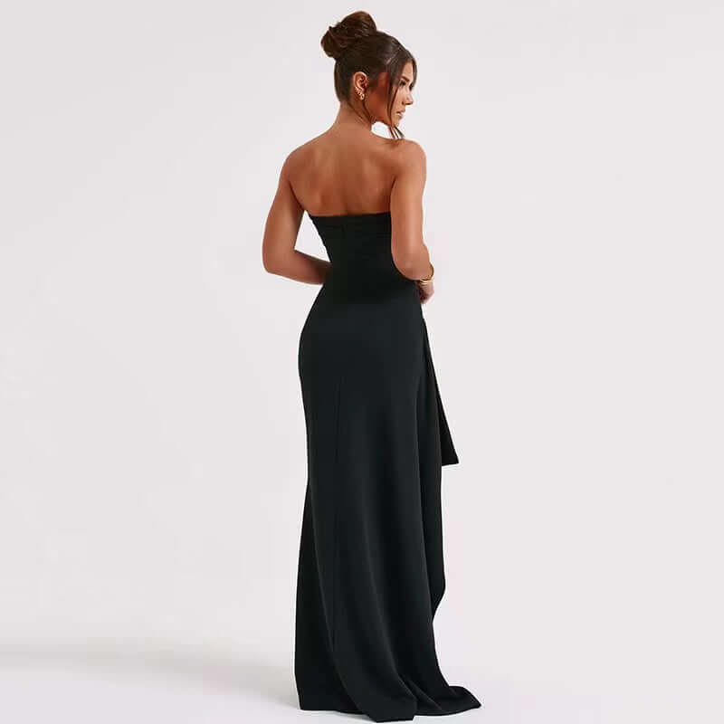 Woman wearing a black strapless gown on a white background