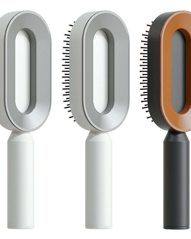 Three grooming brushes with different color handles on a white background