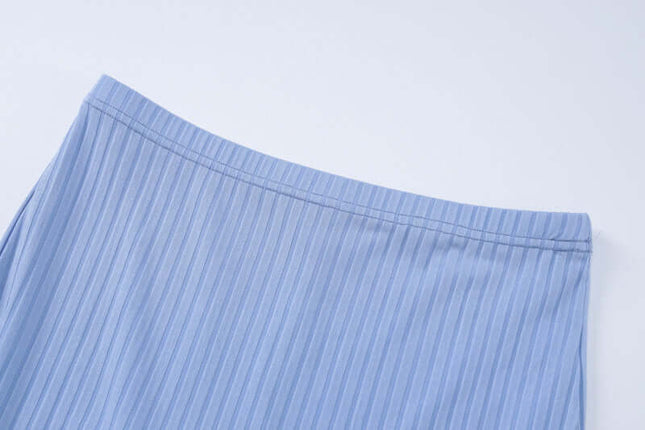 Close-up of blue striped fabric on a light gray background