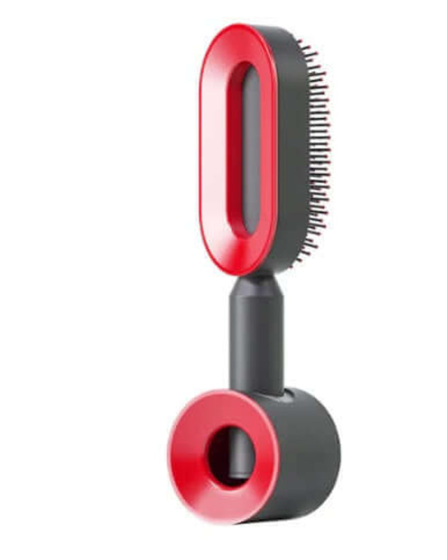 Red and black grooming brush on a white background