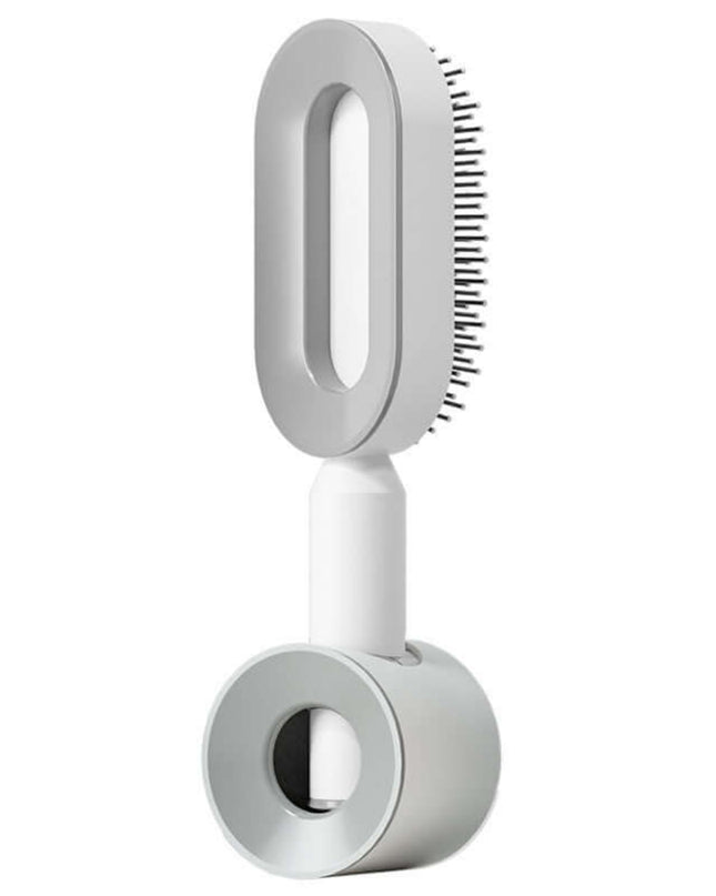 White handheld grooming tool with bristle head on a white background