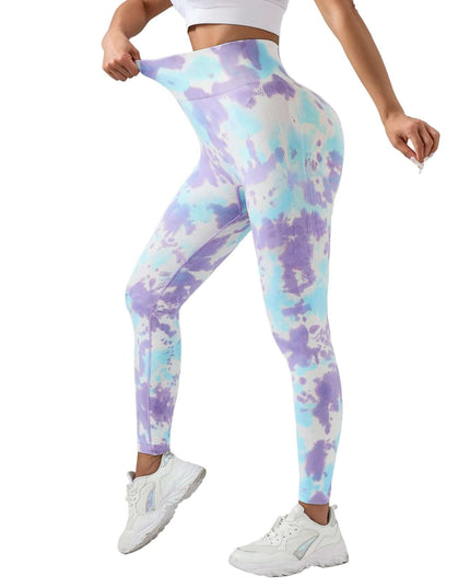 Person wearing tie-dye leggings on a gray background