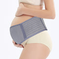 Pregnant woman wearing a blue maternity belt on a white background