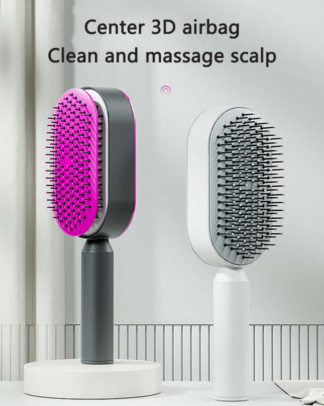 Hairbrush with pink bristle head and gray handle on a white background