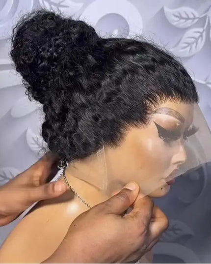 Person adjusting a black lace wig on a mannequin head against a decorative background.