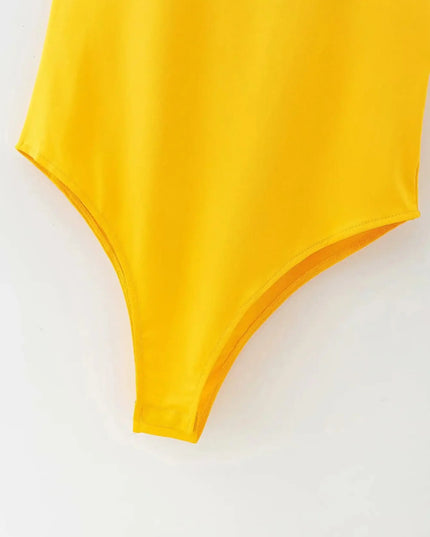 Yellow swimsuit top on a white background