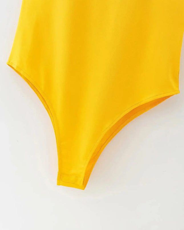 Yellow swimsuit top on a white background