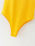 Yellow swimsuit top on a white background