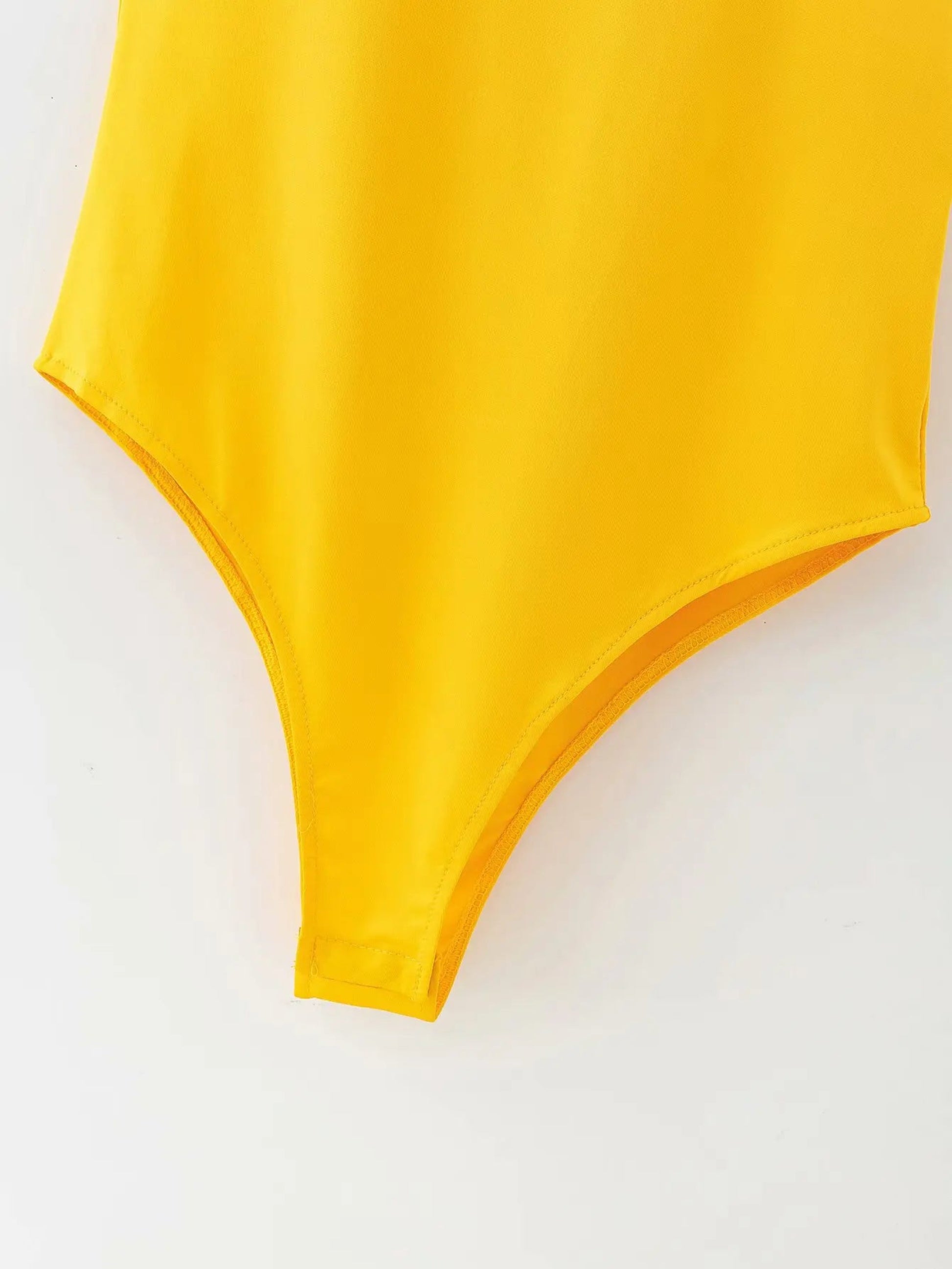 Yellow swimsuit top on a white background