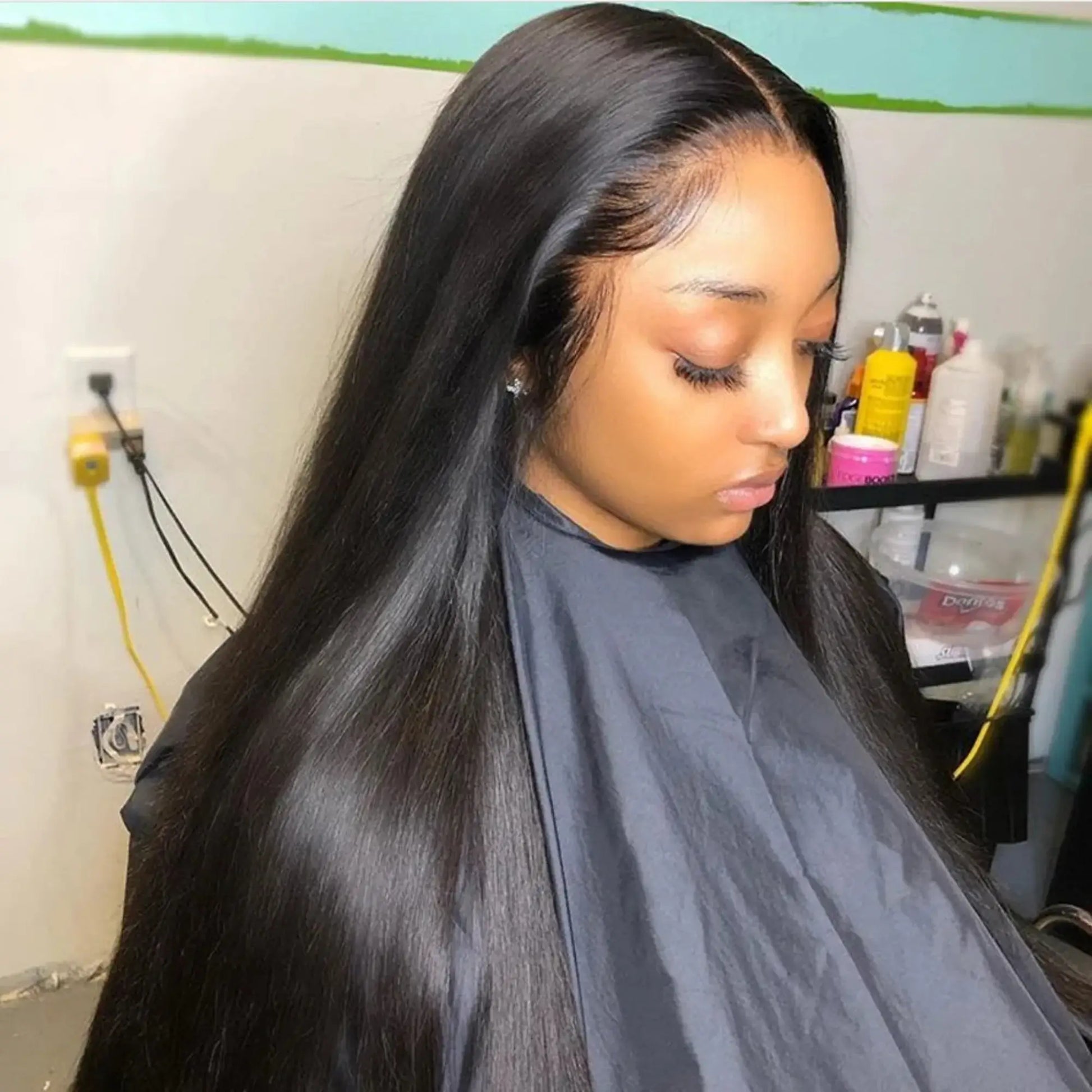 Woman with long black hair in a salon setting