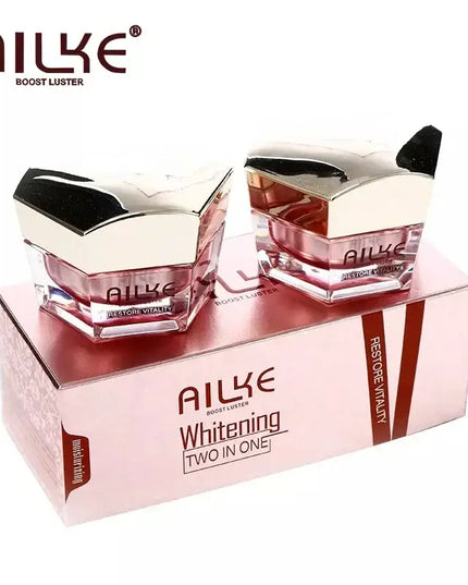AILKE whitening two-in-one face cream jars in a pink box, designed to boost skin luster and hydration.