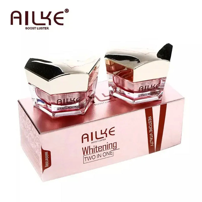 AILKE whitening two-in-one face cream jars in a pink box, designed to boost skin luster and hydration.