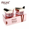 AILKE whitening two-in-one face cream jars in a pink box, designed to boost skin luster and hydration.
