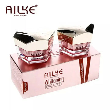 AILKE whitening two-in-one face cream jars in a pink box, designed to boost skin luster and hydration.
