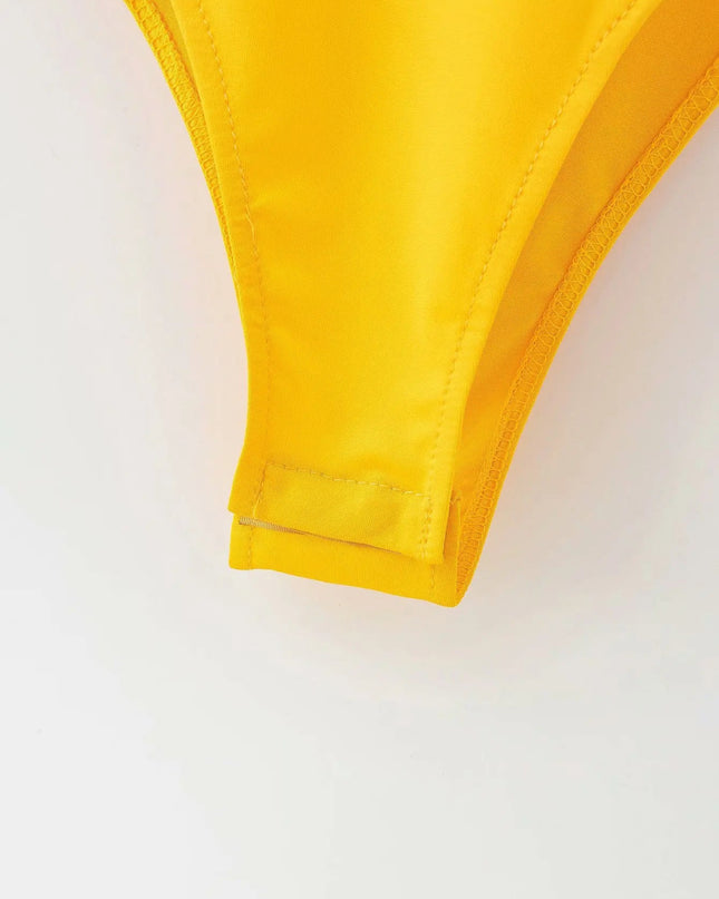 Close-up of a yellow bikini top on a white background