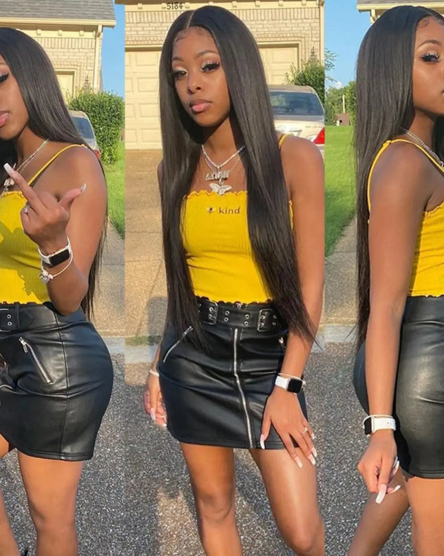 Woman in a yellow top and black leather skirt posing outdoors.