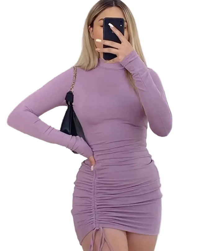 Person wearing a purple dress taking a mirror selfie in a clothing store.