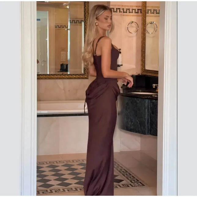 Brown pleated maxi dress showcasing a sleek silhouette in a stylish bathroom setting.