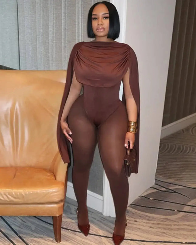 Woman in a brown outfit standing in a room with a beige couch.