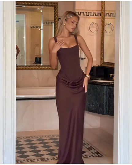 Elegant model wearing a brown pleated maxi dress, showcasing its flattering fit and sophisticated design.