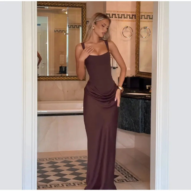 Elegant model wearing a brown pleated maxi dress, showcasing its flattering fit and sophisticated design.