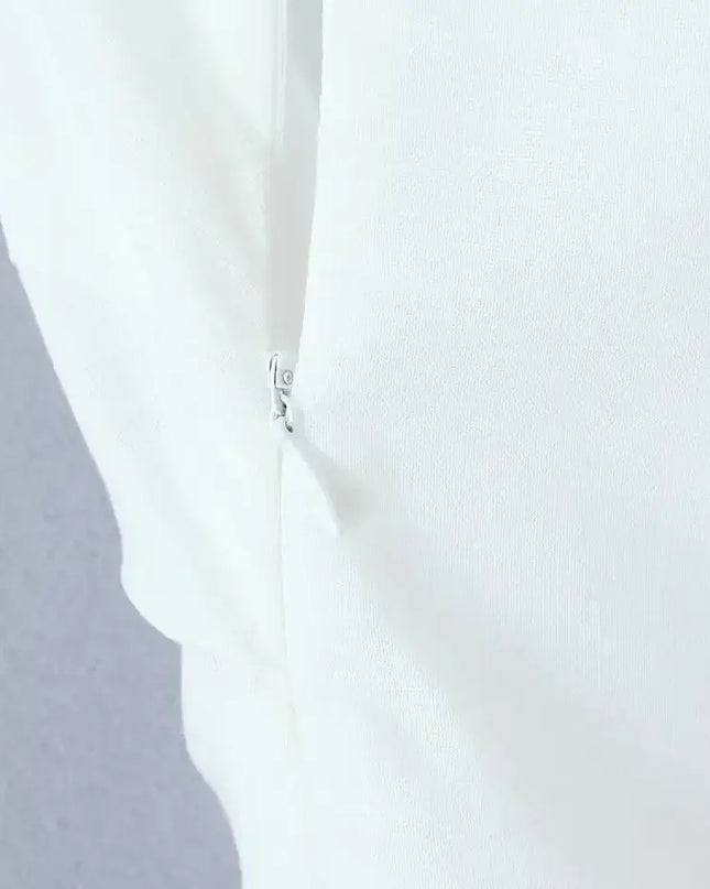 Close-up of zipper detail on a white cotton linen summer dress, showcasing quality craftsmanship.