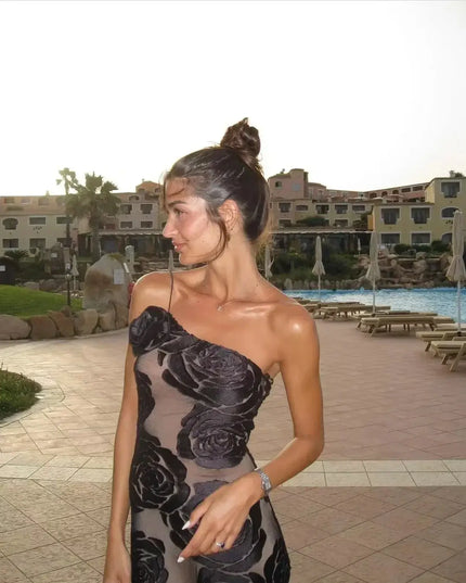 Oligai one shoulder elegant dress model wearing sexy mesh bodycon design by the poolside at sunset.