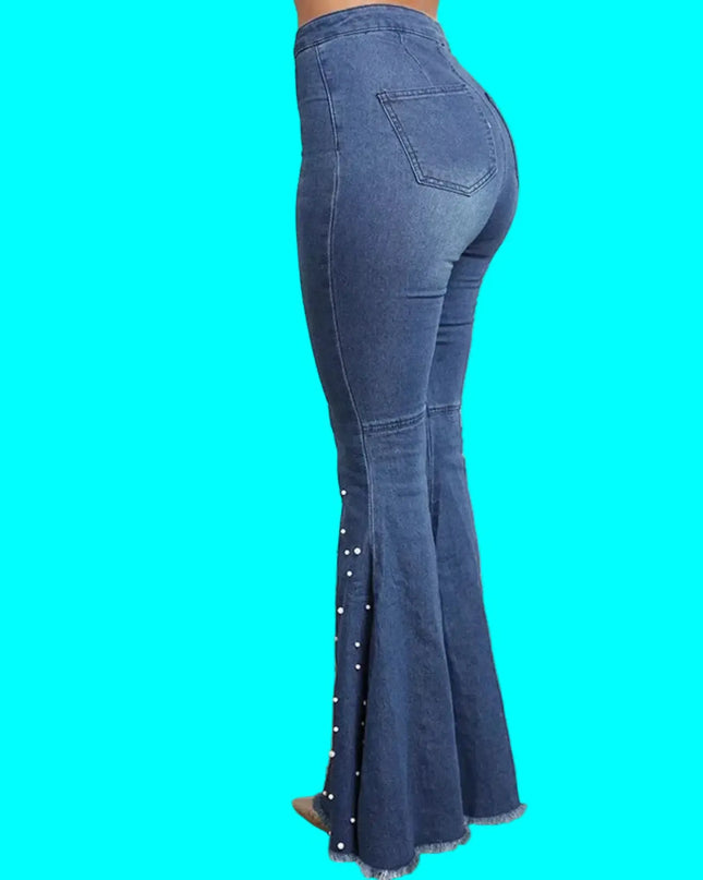 Blue flared jeans with decorative elements on a turquoise background