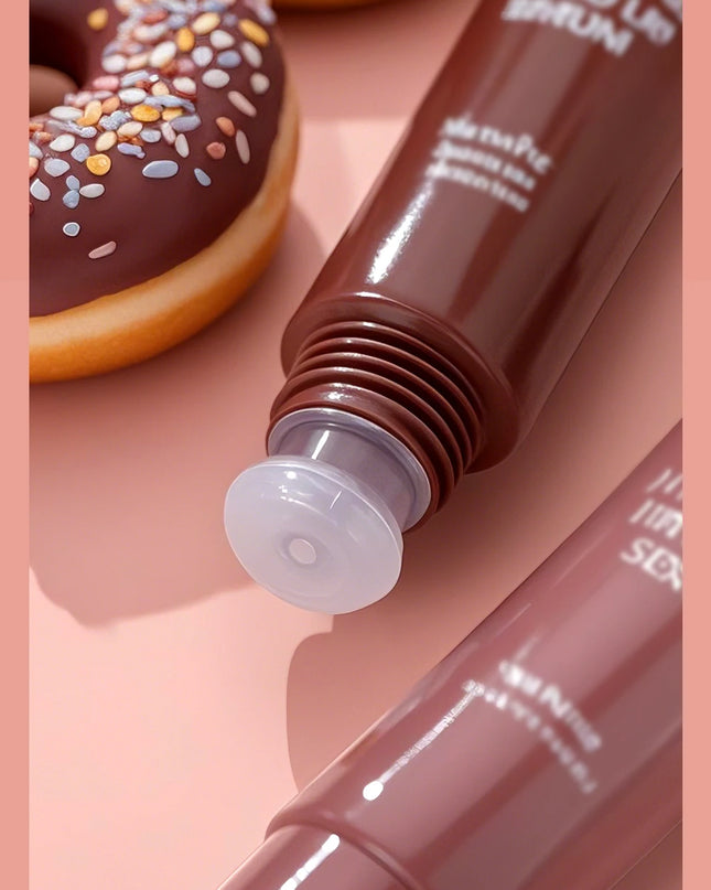 Two lip glosses on a pink background with a chocolate donut.