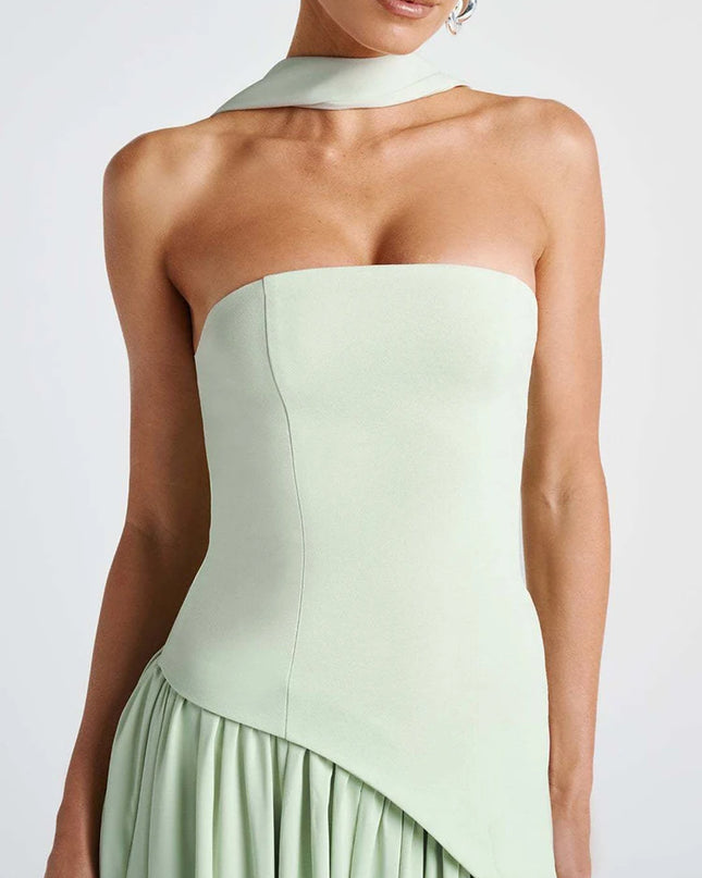 Light green strapless dress worn by a model on a plain background