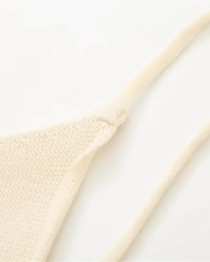 Close-up of KADUWAKI Gothic embroidered dresses for women, showing a knitted detail in a light color.