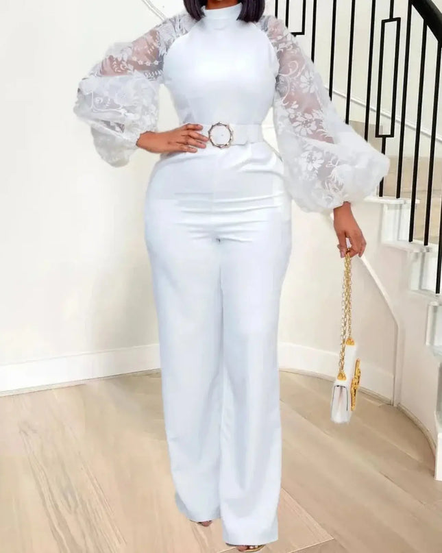 Person wearing a white outfit with sheer sleeves in a home setting.