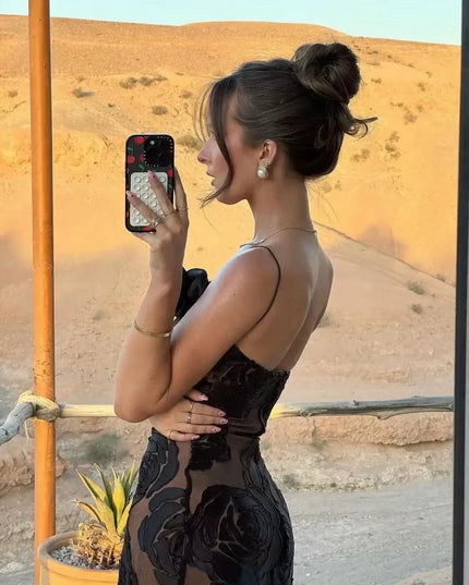 Oligai one shoulder elegant dress worn by a woman posing outdoors with a scenic background.