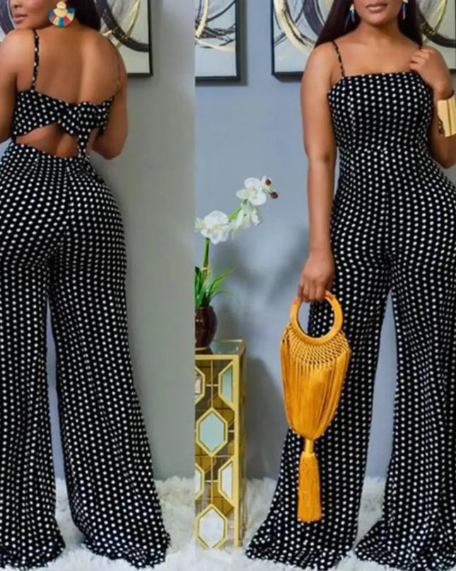 Woman wearing a black and white polka dot jumpsuit holding a yellow handbag.