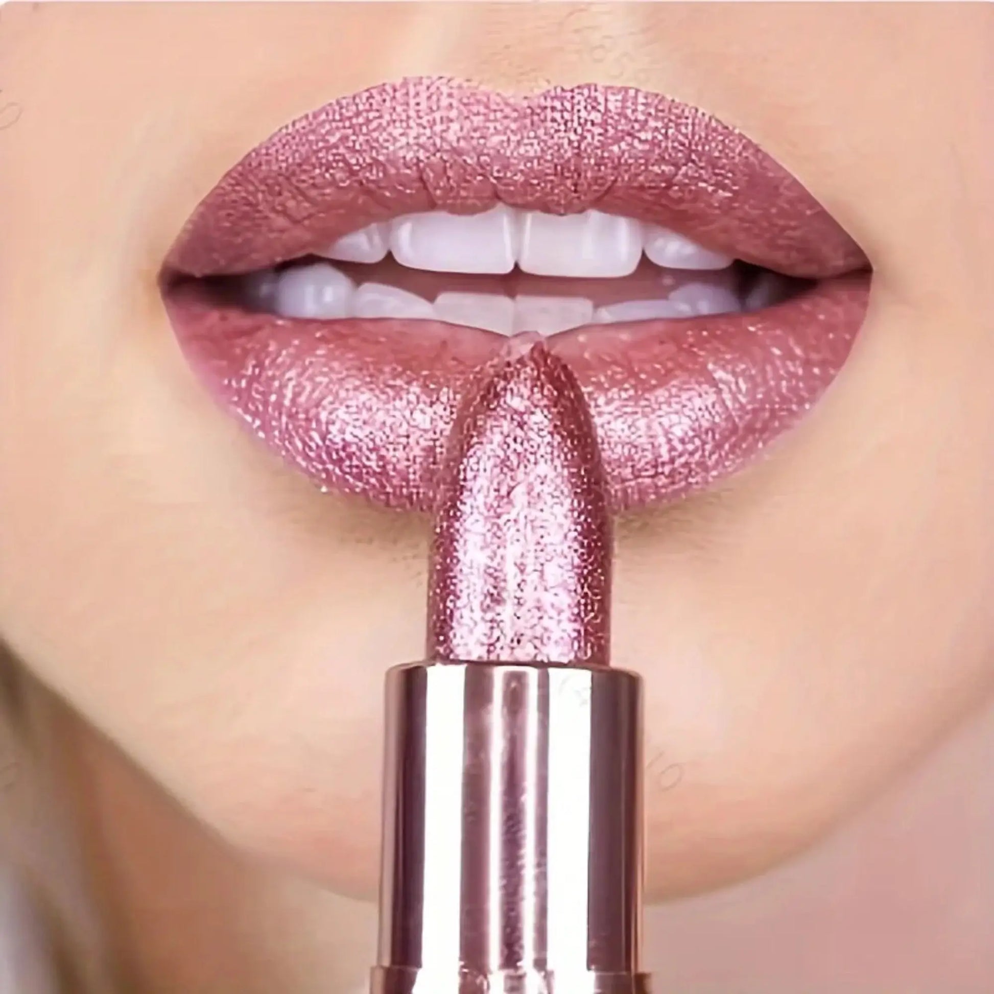Close-up of a pink lipstick being applied to lips with a blurred background