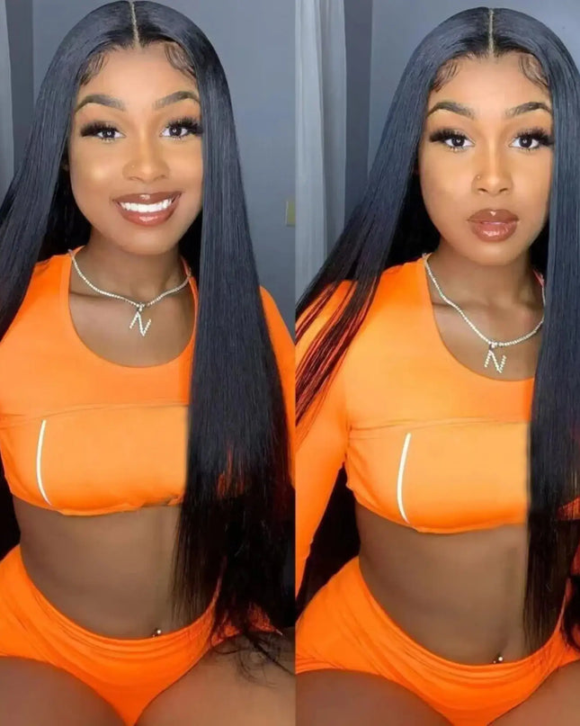 Woman wearing an orange outfit with a black wig against a neutral background