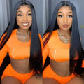 Woman wearing an orange outfit with a black wig against a neutral background