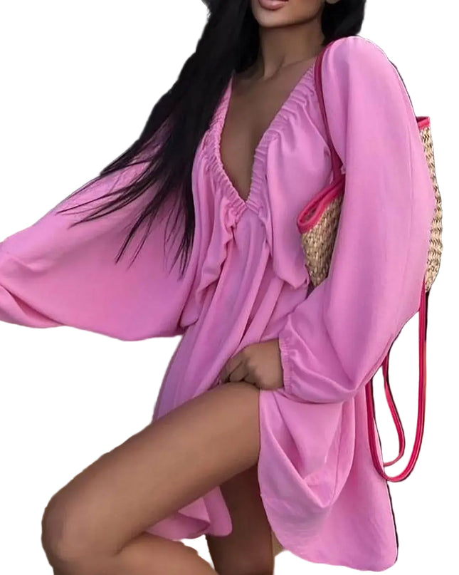 Model wearing a pink deep V-neck pleated dress with long sleeves and a stylish bag, showcasing a sexy retro vibe.