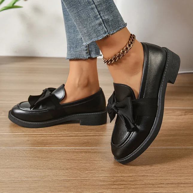 Bow tie loafers for women in black, featuring a stylish bow decoration and low-top design for fashionable everyday wear.