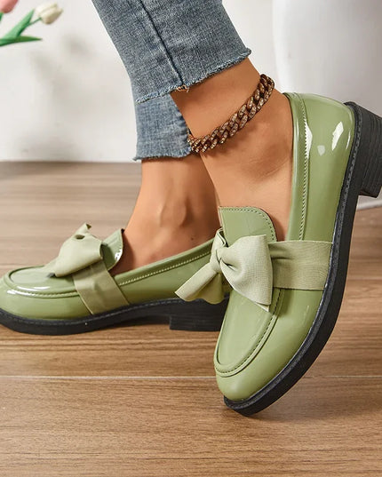 Bow tie loafers for women in green with medium heel and round toe for a stylish daily wear look.