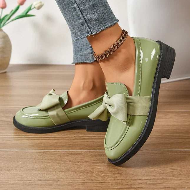 Bow tie loafers for women in green with medium heel and round toe for a stylish daily wear look.