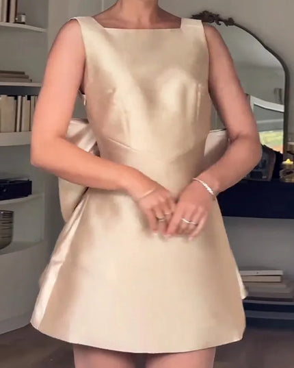 Woman wearing a beige dress in an indoor setting